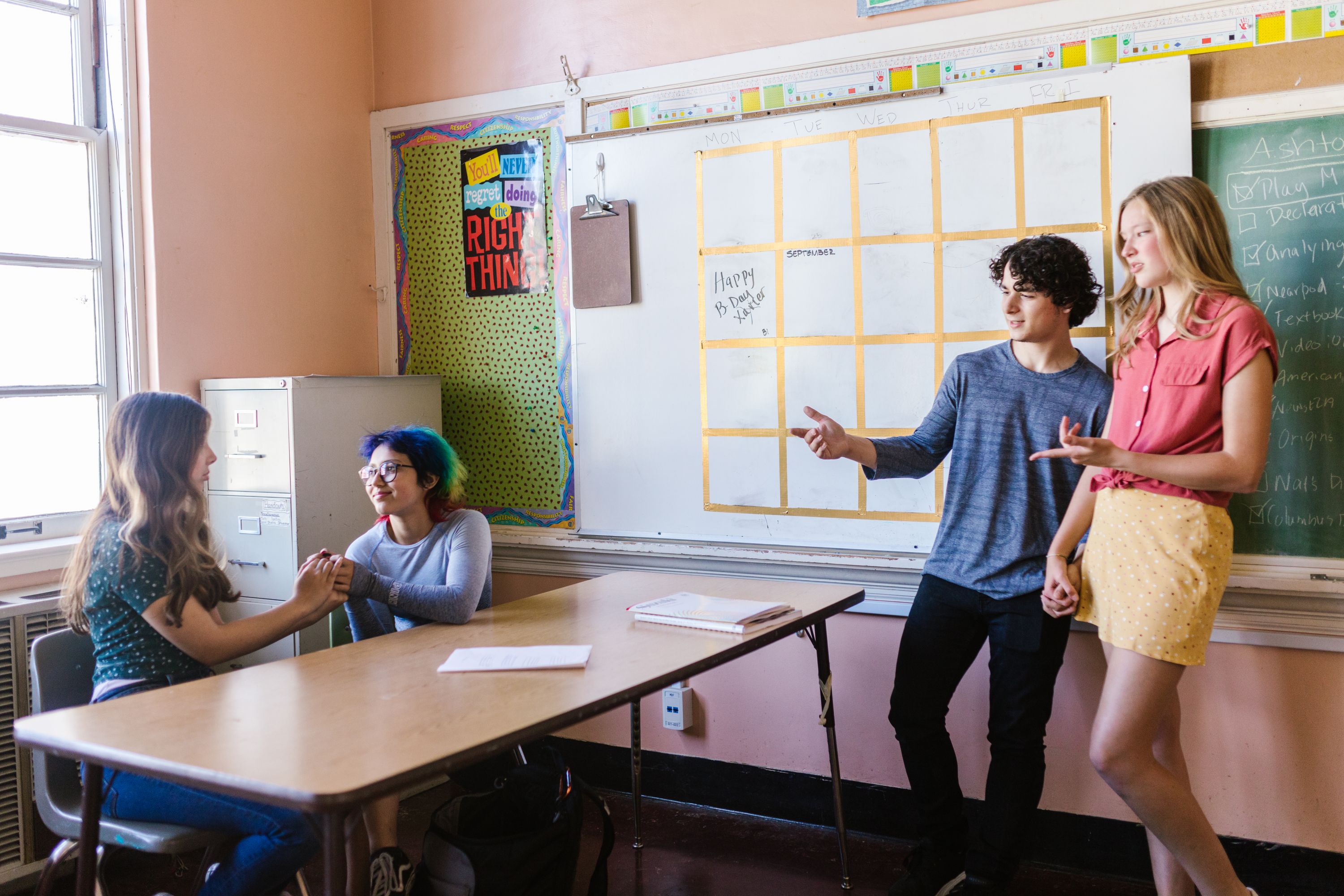 High school students discussing a group activity in a classroom — illustrative education photography