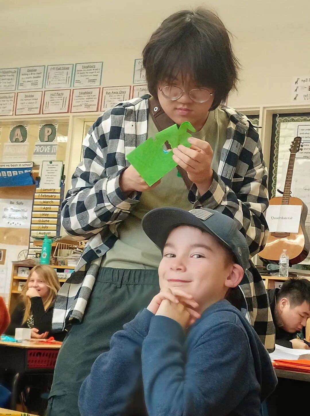 Visiting students leading an activity for younger children
