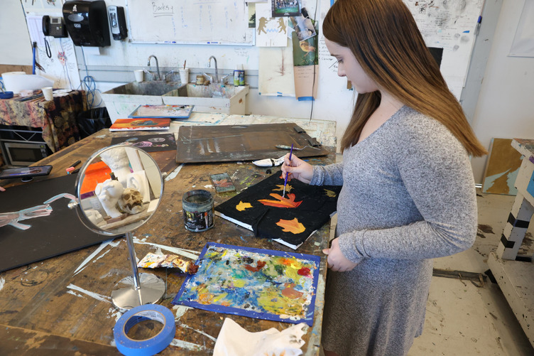 A North Yarmouth Academy student painting in the art studio